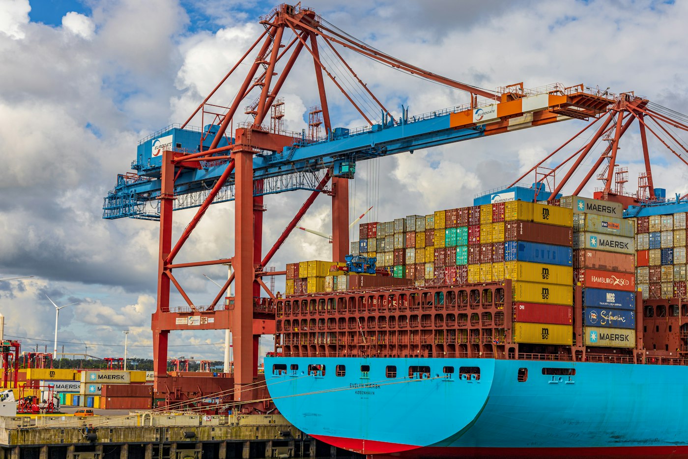 Container ship at a port, representing trade connections between businesses