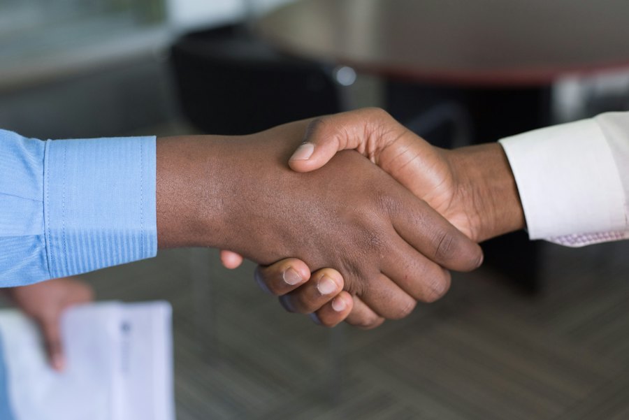 Illustrative close-up business introduction handshake