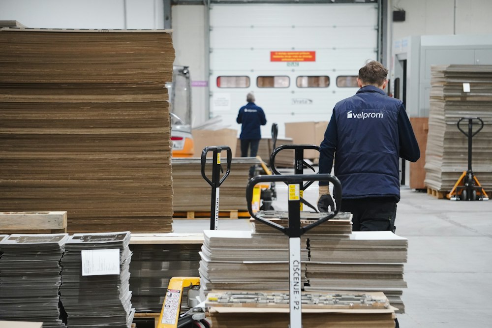 How to Source Products from South Korea: A Wholesale RFQ Checklist (2026) 2 Warehouse worker moving boxed goods, illustrative of an international product sourcing workflow